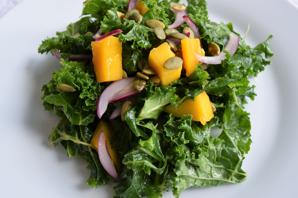 A simple, healthy and delicious massaged kale and mango salad. Low in calories and carbohydrates, it makes a perfect lunch salad.